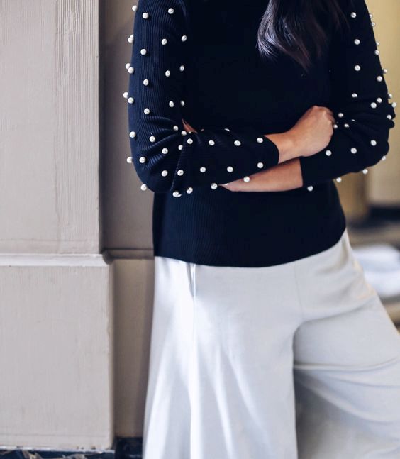 10-a-navy-sweater-contrasts-large-white-pearls-on-the-sleeves-and-neutral-culottes